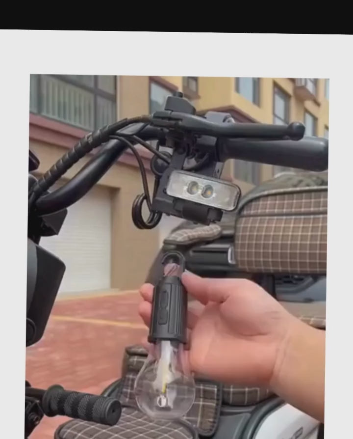 Person holding a rechargeable LED hanging bulb attached to a bike handle, showcasing versatile outdoor lighting.